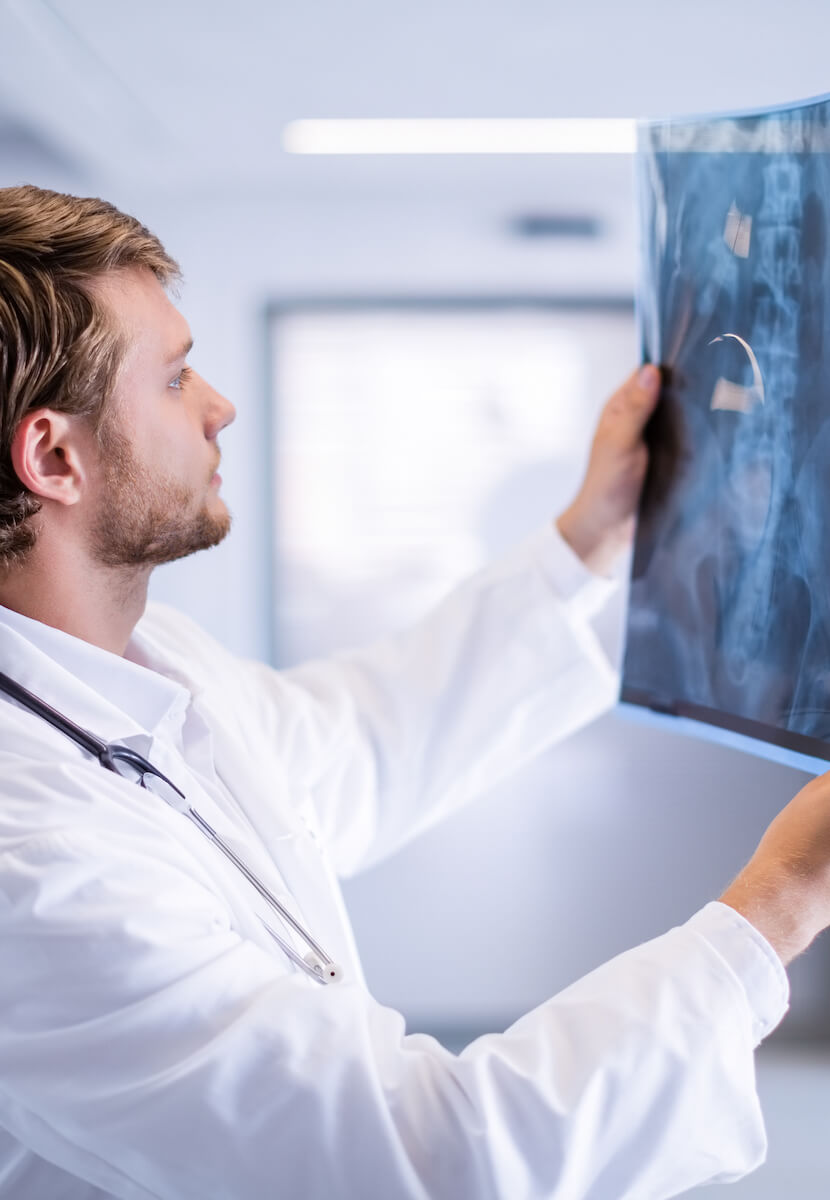 male-doctor-examining-x-ray-in-corridor-2023-11-27-05-07-50-utc_crop.jpg